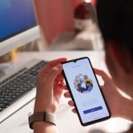 Woman holding a phone with Microsoft Teams starting